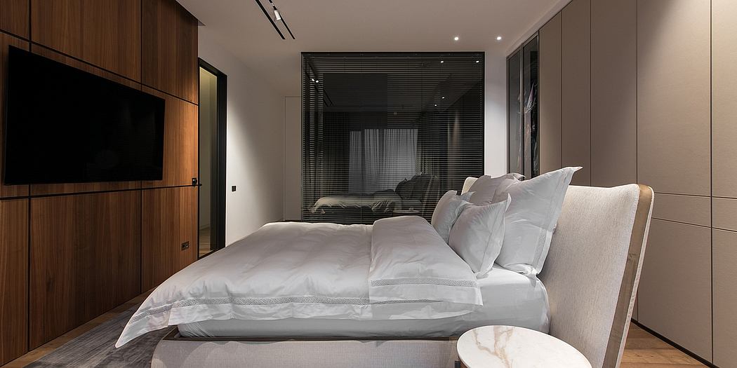 Luxurious bedroom with modern furniture, warm lighting, and neutral color palette.