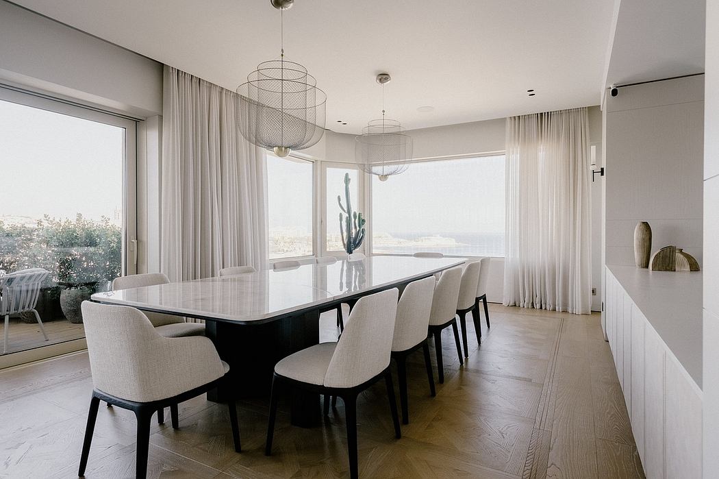 Elegant dining room with modern chandelier, floor-to-ceiling windows, and neutral decor.