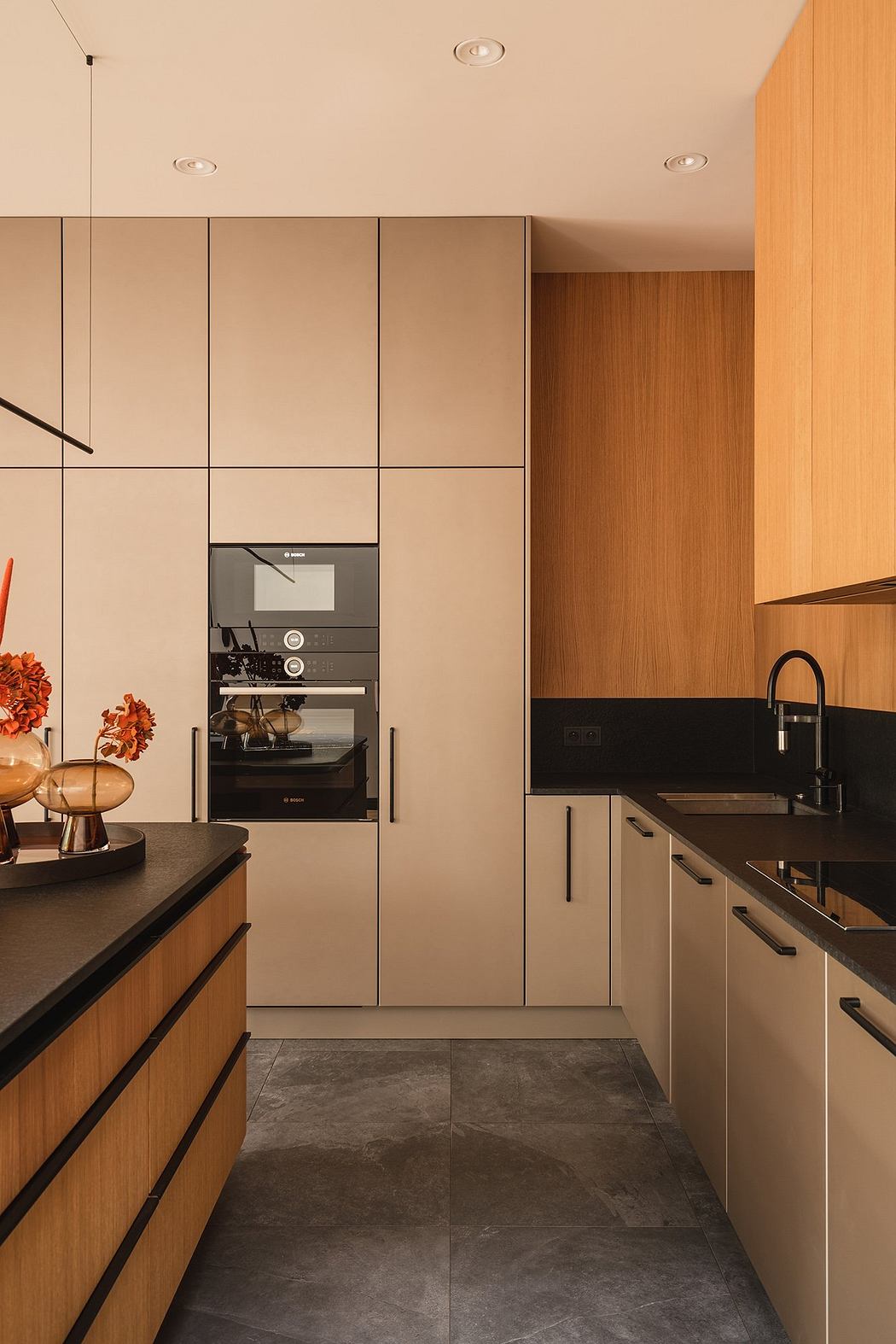 A well-designed kitchen with sleek cabinetry, built-in appliances, and complementary tile flooring.