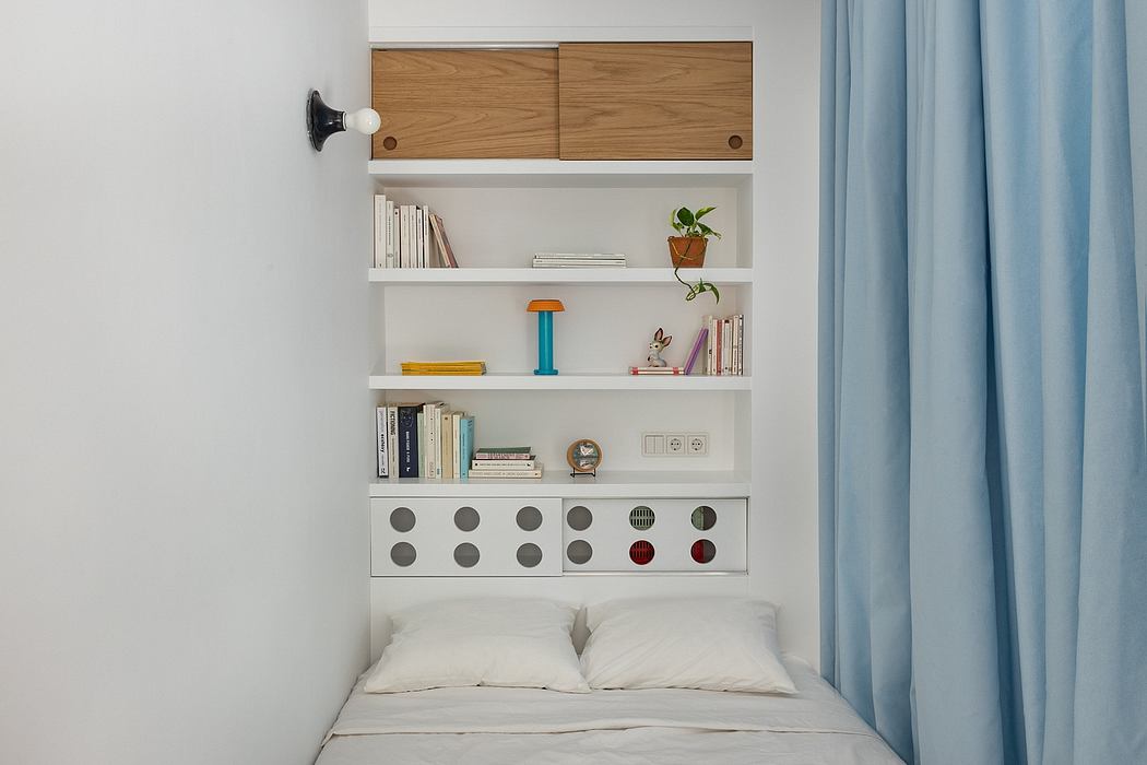 Minimalist bedroom with built-in shelving, drawer units, and neutral color palette.