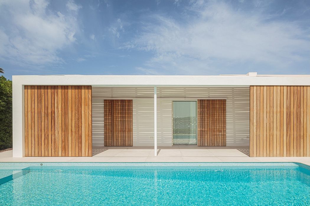 Modern single-story home with minimalist design, wooden accents, and a swimming pool.