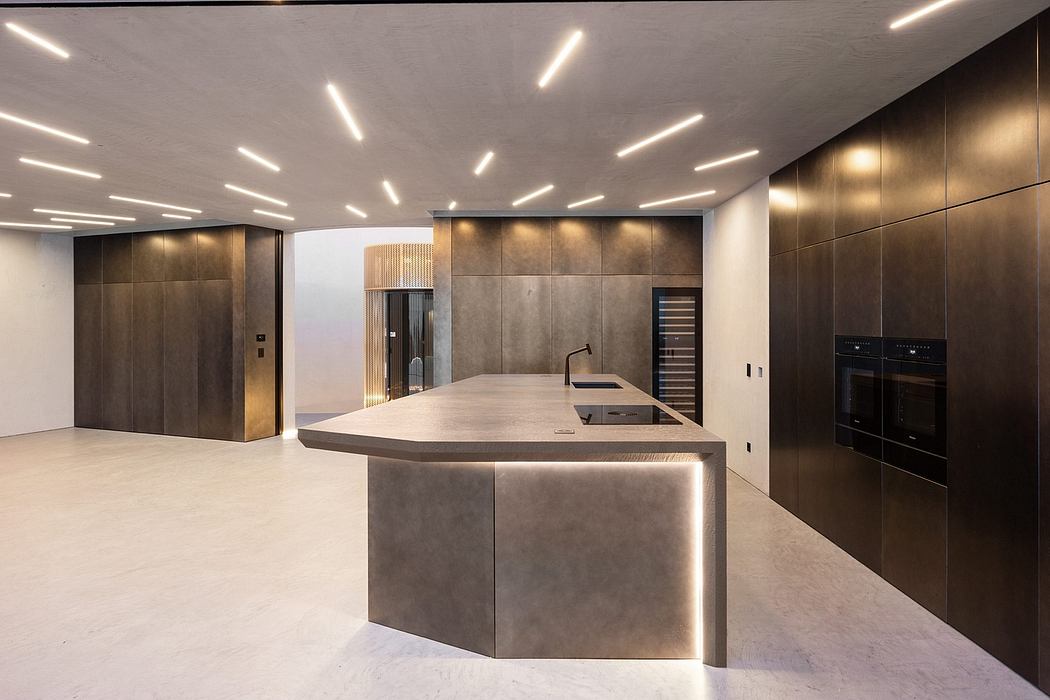 Modern, sleek kitchen with concrete countertops, recessed lighting, and dark wooden cabinetry.