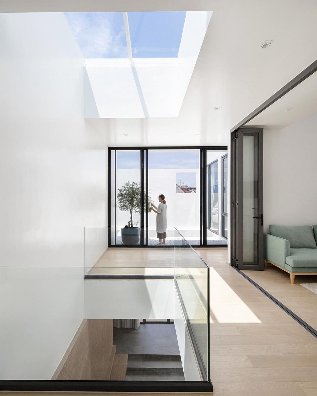 Sleek, modern living space with large windows, minimalist furniture, and natural light.