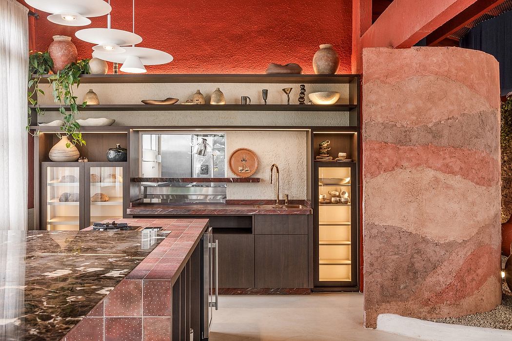 A warm, earthy kitchen with textured walls, built-in shelves, and a granite countertop.