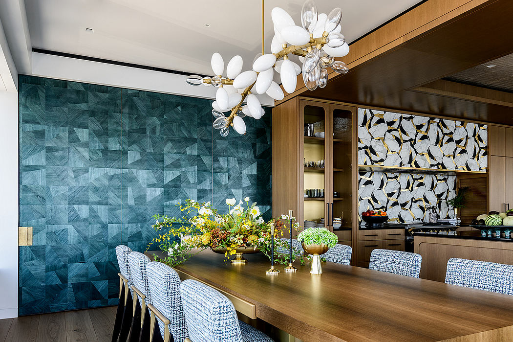 Elegant dining area with striking green tile wall, wooden table, and flower arrangement.