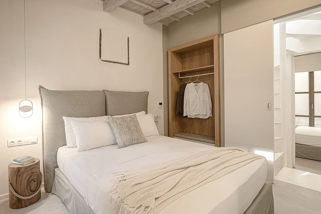 A modern bedroom with a built-in wardrobe, soft lighting, and natural wood accents.