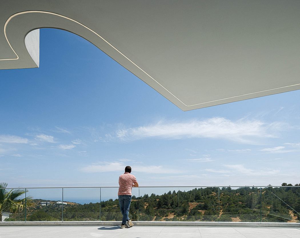 Striking architectural design featuring a curved canopy frame against a blue sky.
