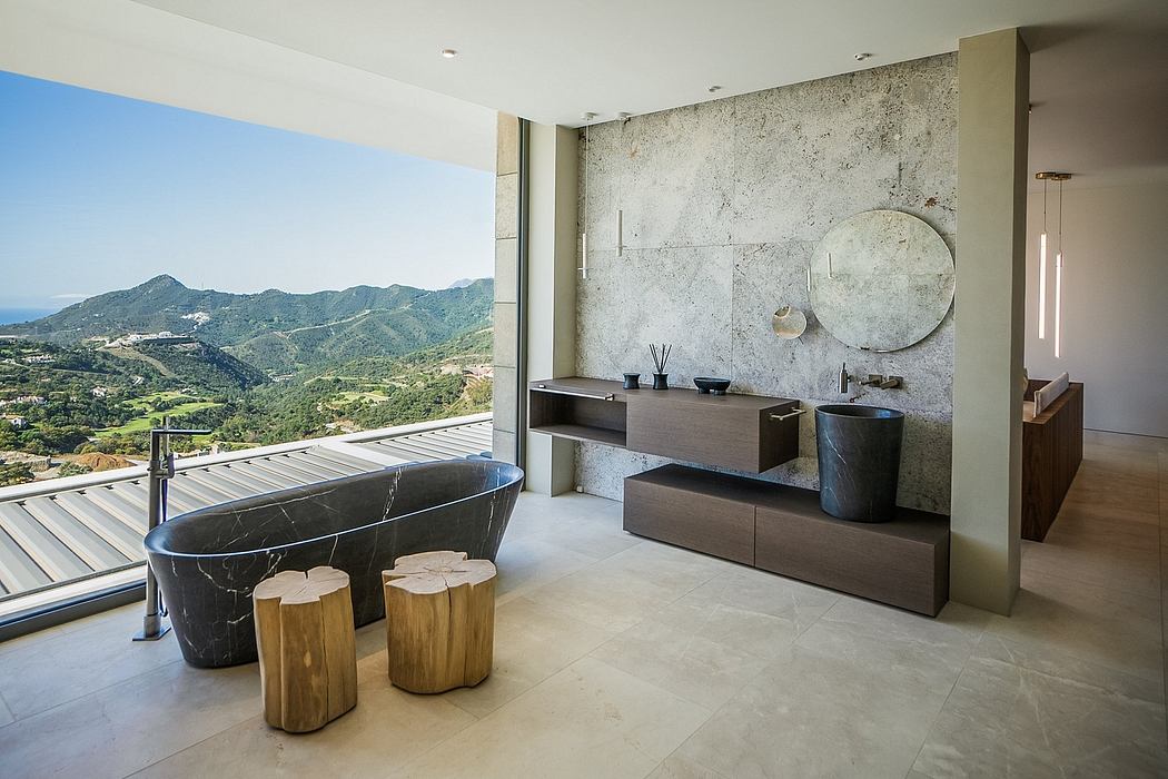 Modern luxury bathroom with floor-to-ceiling windows, black marble tub, and rustic wooden stools.