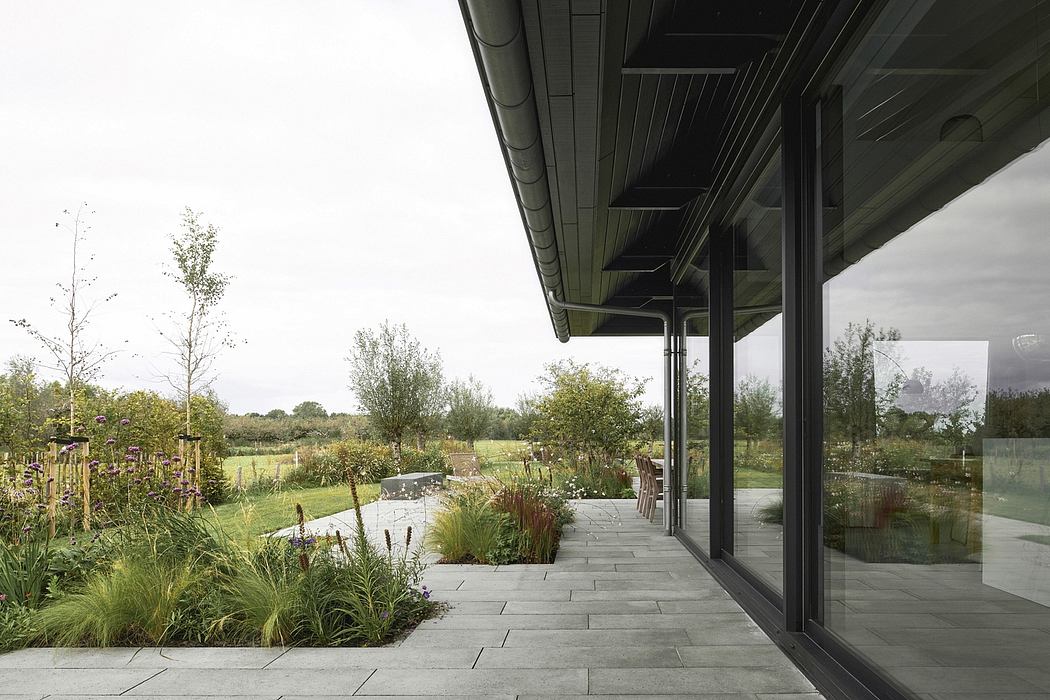Expansive glass patio doors offer sweeping views of a lush, thoughtfully landscaped garden.