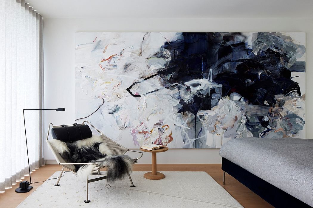 Sleek, modern living space with abstract artwork and minimalist furnishings.