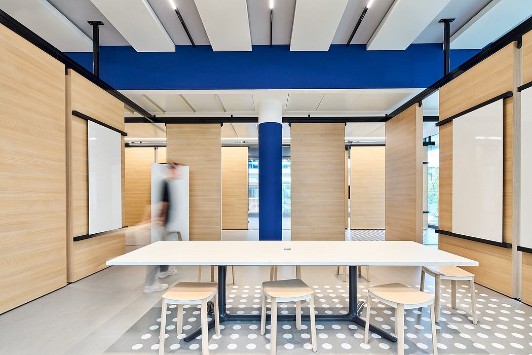 Sleek, modern office space with wood paneling, blue accents, and polka-dot flooring.