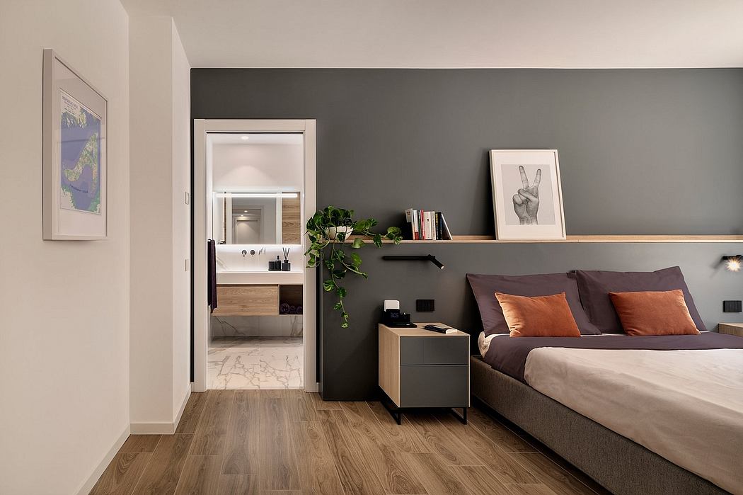 Minimalist bedroom design with dark gray walls, wooden flooring, and modern furnishings.