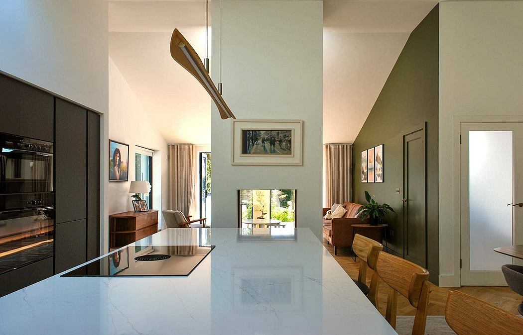 Stylish modern kitchen with sleek marble countertop, wooden furnishings, and art decor.