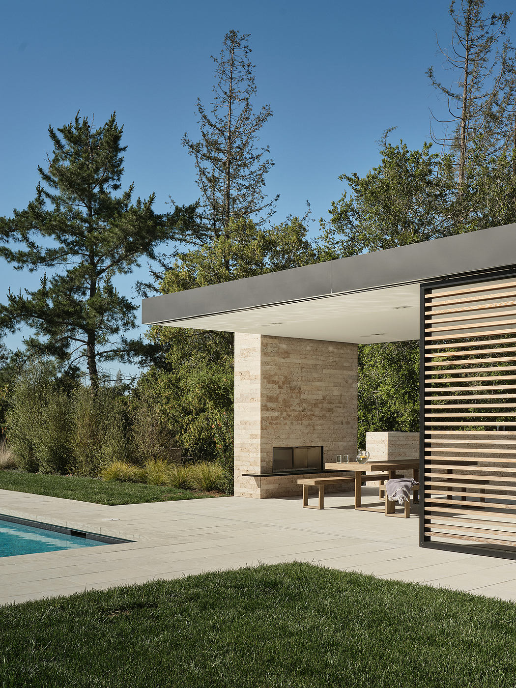 Sleek modern architecture with concrete and wood structures, surrounded by lush greenery.