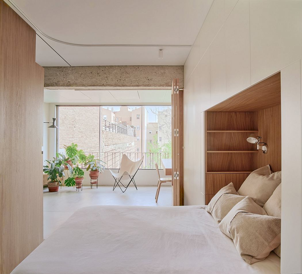 Minimalist bedroom with wooden shelving, large window, and comfortable furnishings.