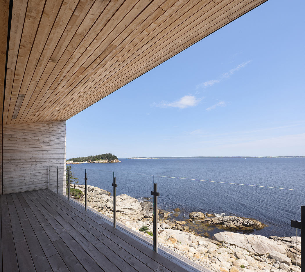 Wooden deck overlooking a rocky coastline with a view of the distant ocean.