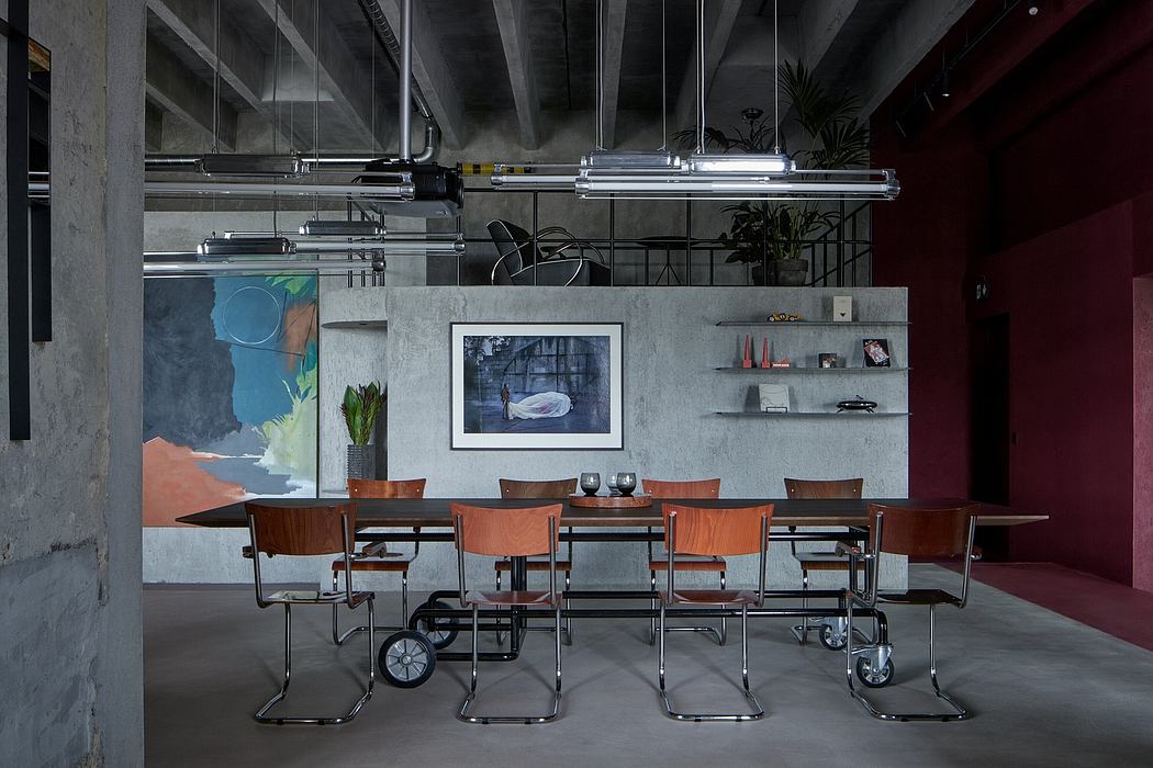 Minimalist industrial-style dining room with concrete walls, steel beams, and modern furniture.