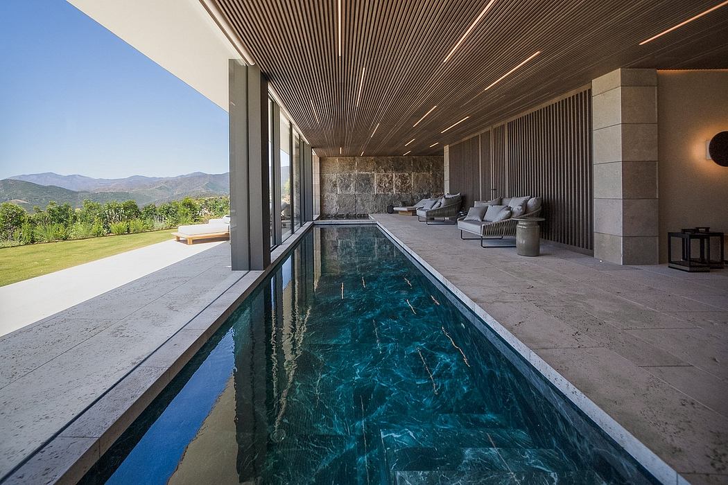 Luxurious pool pavilion with sleek wood paneling, stone walls, and serene mountain views.