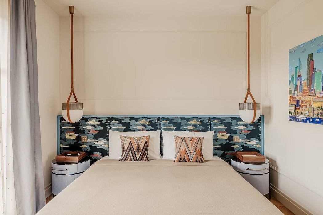 Stylish bedroom with custom headboard, modern lighting, and geometric decor accents.