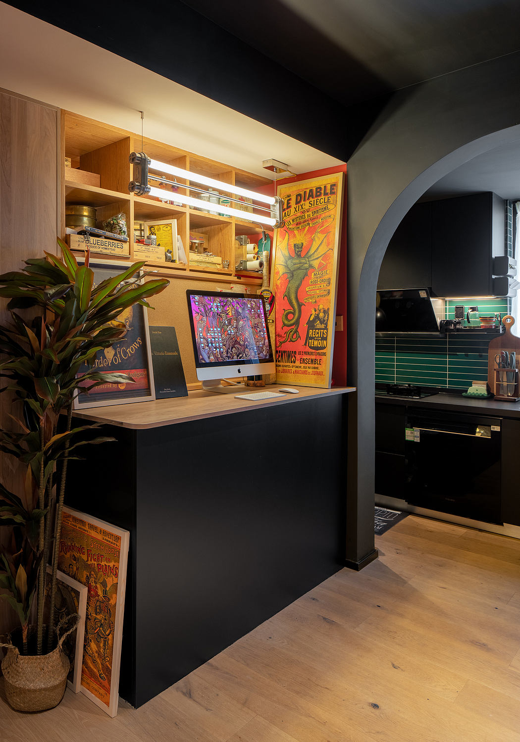 Warm-toned workspace with vintage poster, bookshelves, and retro appliances.