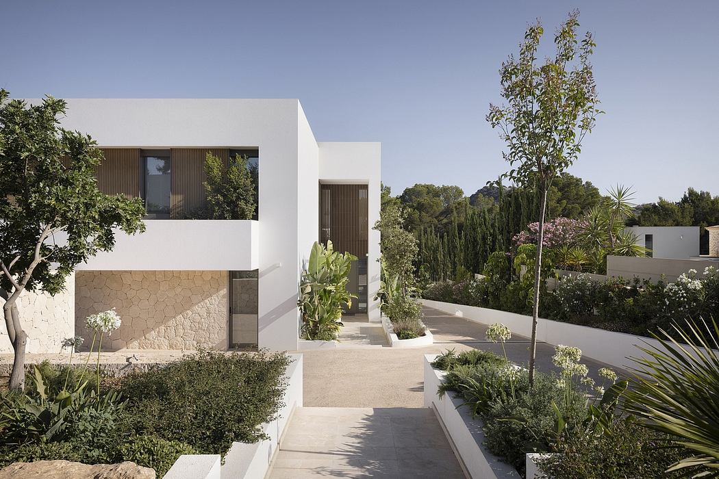 Stylish minimalist architecture with lush Mediterranean landscaping.
