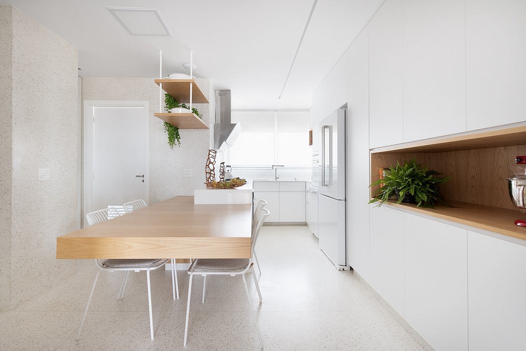 Sleek, modern kitchen with minimalist design, open shelves, and a wooden dining table.