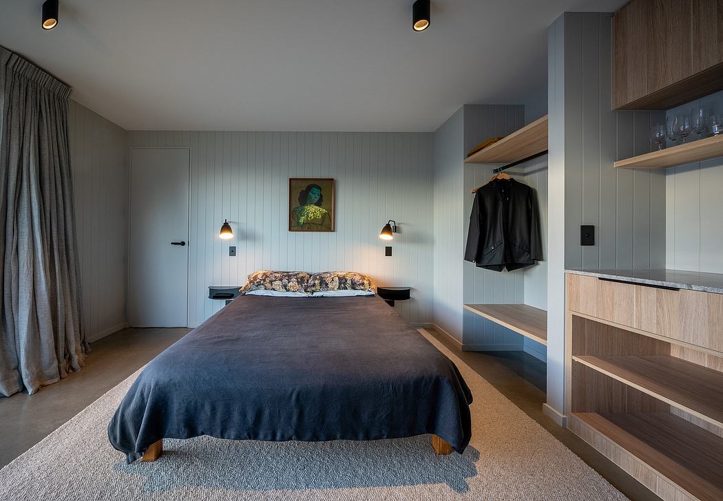 Cozy modern bedroom with wood paneled walls, built-in shelving, and recessed lighting.