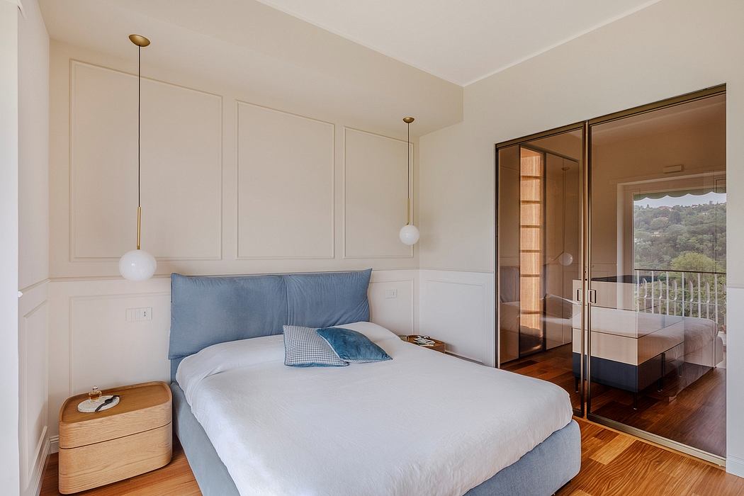 Spacious bedroom with minimalist decor, wooden floors, and glass sliding door leading to a balcony.