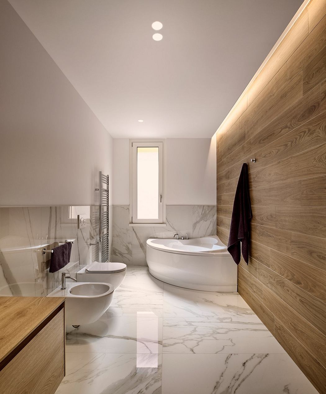 Sleek and modern bathroom design with marble flooring, wooden accents, and freestanding tub.