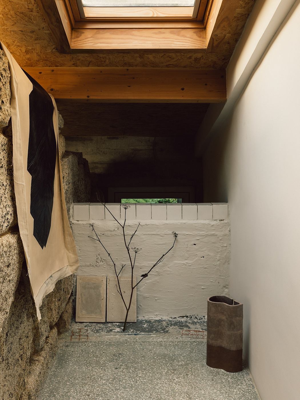 A cozy, rustic nook with wooden beams, exposed brick, and minimal decor creates a serene atmosphere.