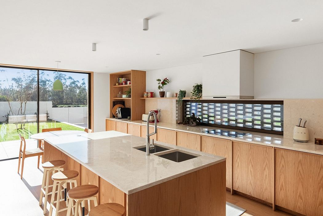 Spacious, contemporary kitchen with wooden cabinets, stone countertops, and integrated appliances.