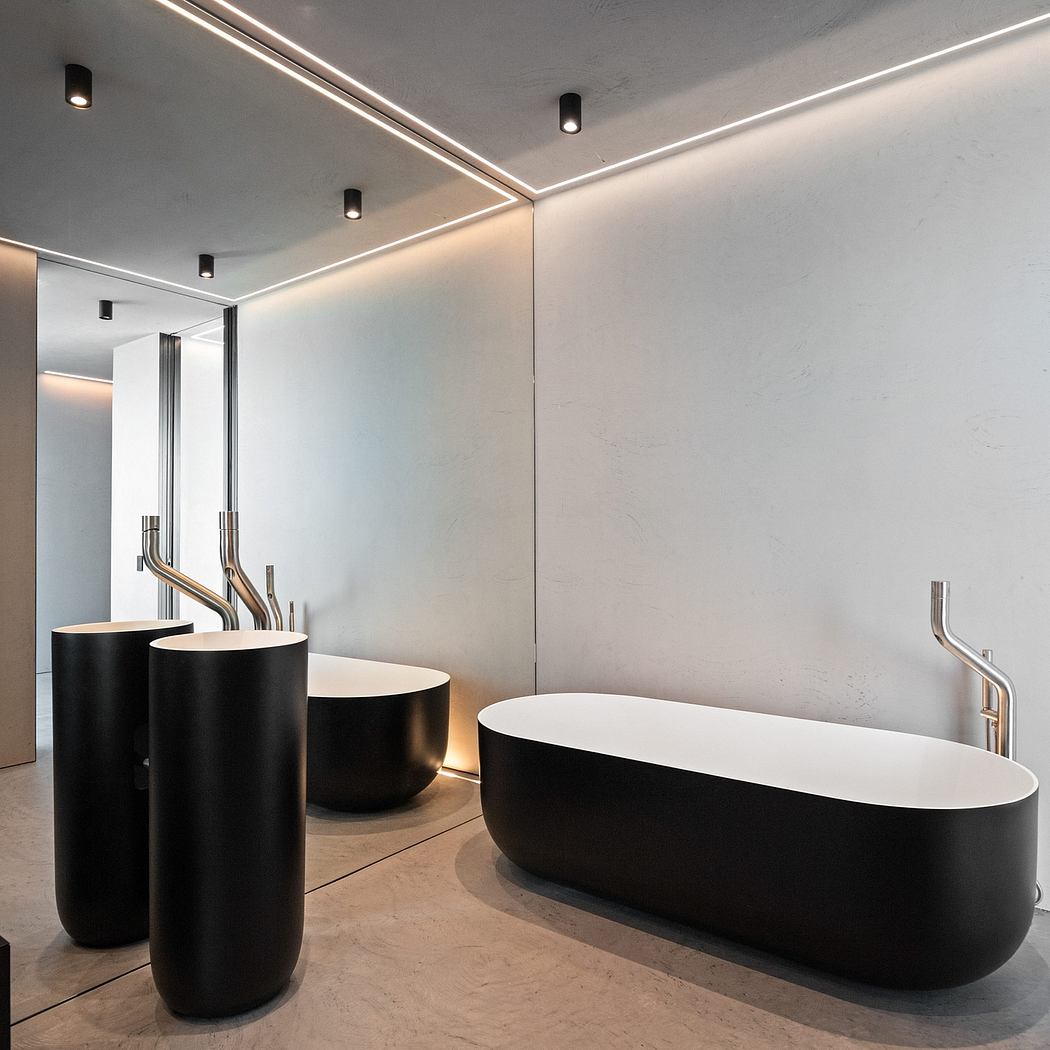 Striking modern bathroom with sleek black sinks, minimalist metallic fittings, and recessed lighting.