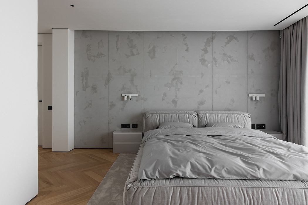 Minimalist bedroom with textured concrete wall, floating nightstands, and hardwood floor.