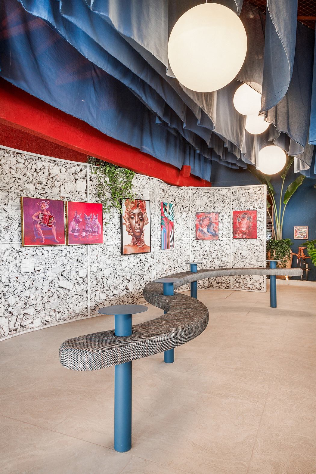 Contemporary lounge with vibrant abstract art, wavy blue curtains, and sculptural seating.