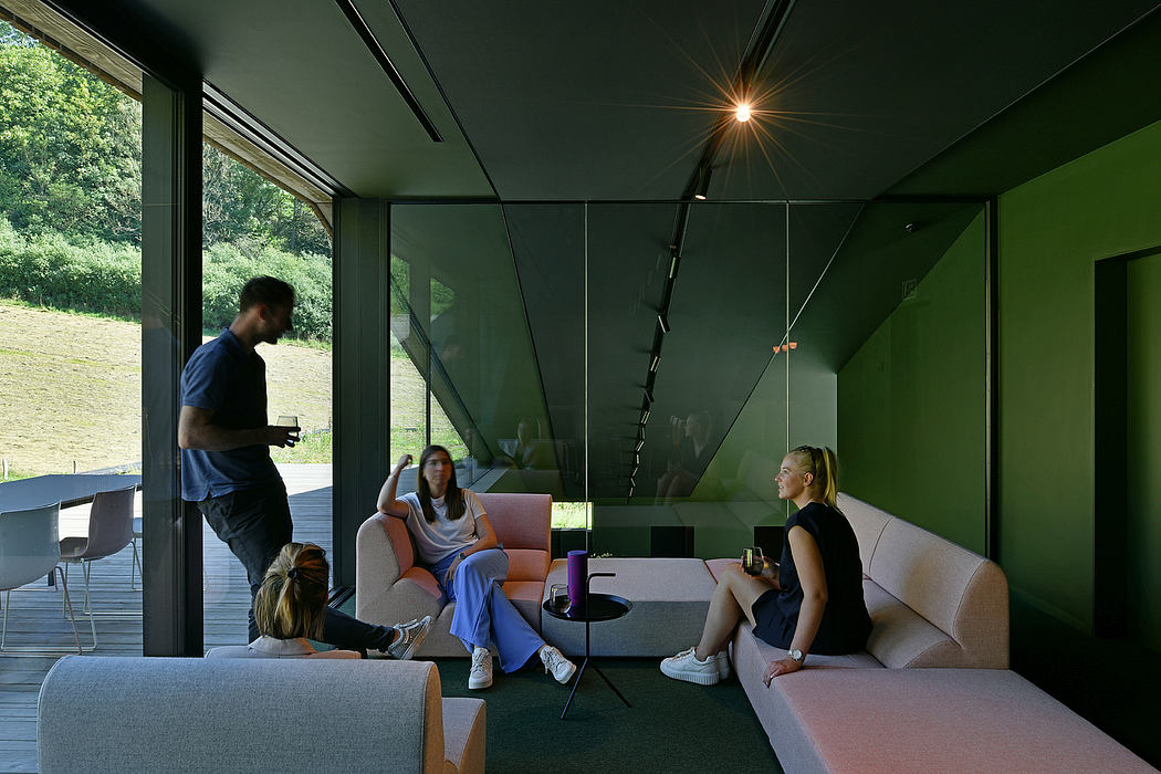 Sleek, modern interior with glass walls, contemporary furniture, and a cozy lounge area.