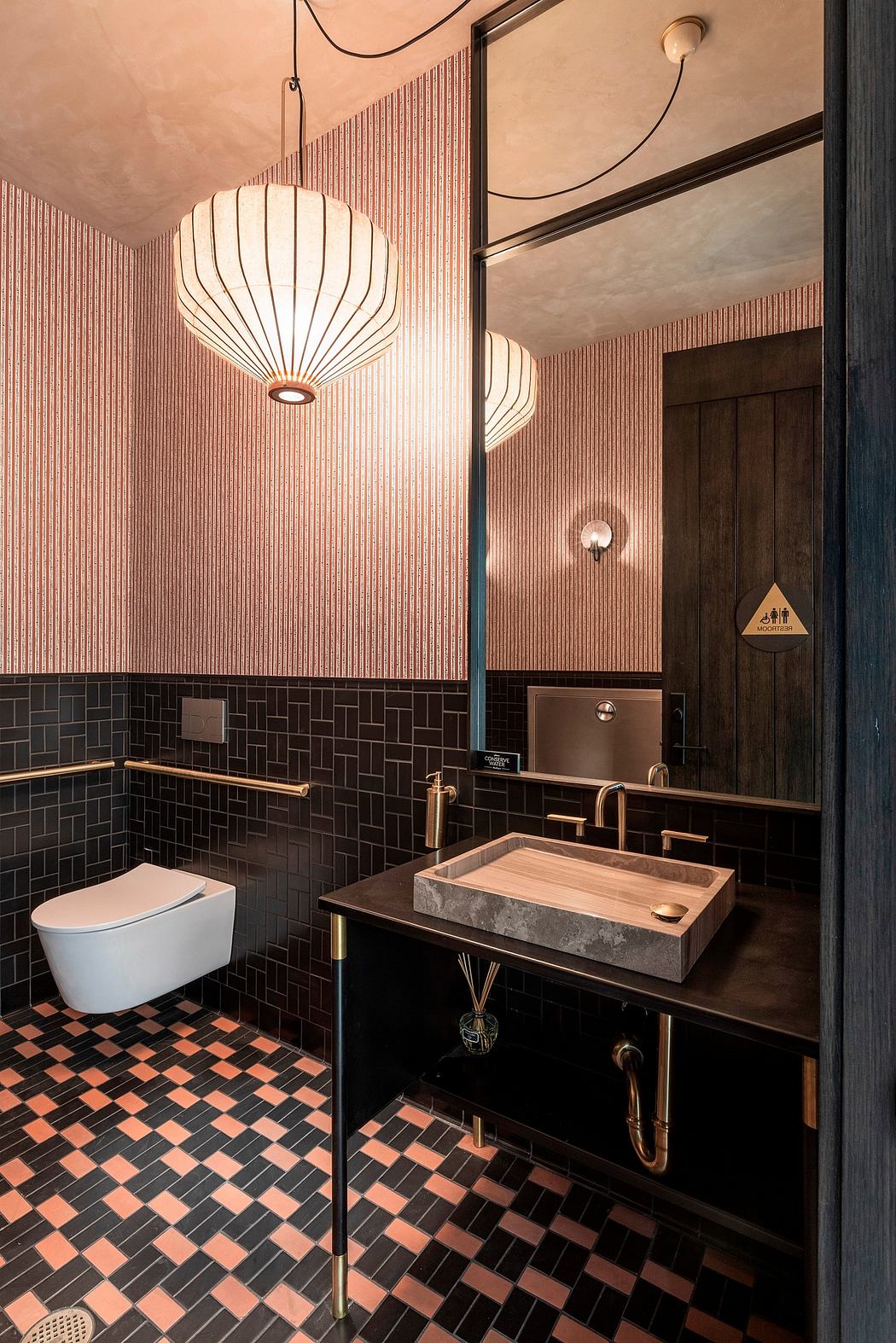 Vibrant, modern bathroom design features pendant lighting, patterned tiles, and unique vanity.