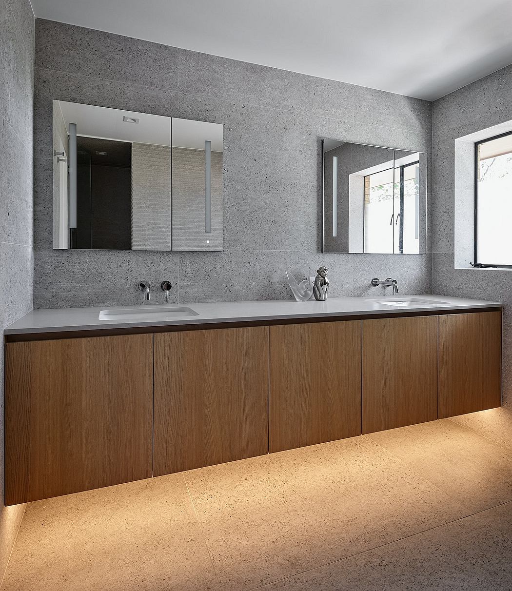 Spacious bathroom with modern, minimalist design featuring gray stone walls and wood vanity.