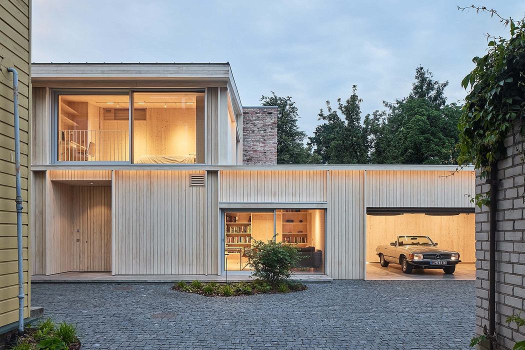 A modern house with a mix of wood, brick, and glass elements, showcasing an integrated garage.