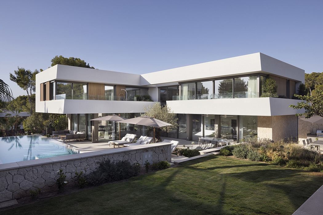 Modern, multi-level residence with sleek, geometric design, expansive glass walls, and pool.