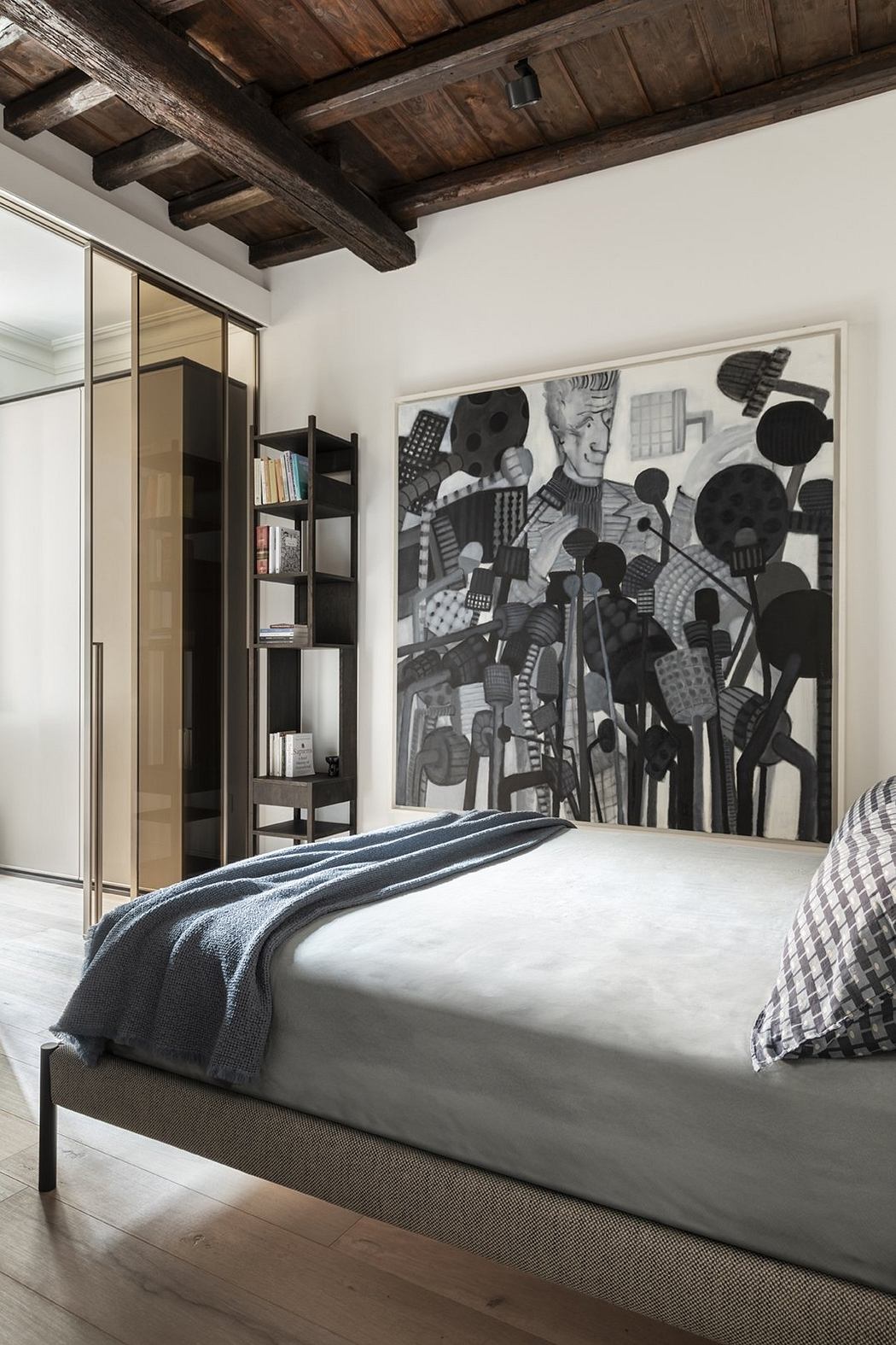 Rustic wooden beams, sleek built-in shelving, and a striking abstract artwork create a cozy, modern bedroom.