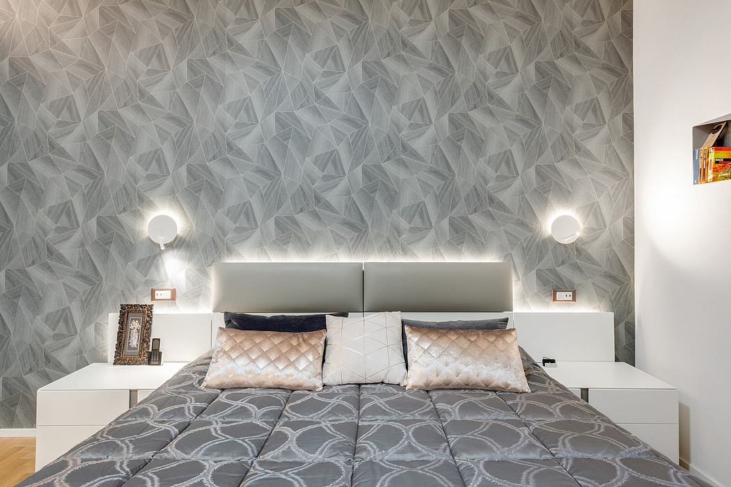 A modern bedroom with a geometric wallpaper pattern, recessed lighting, and minimalist furniture.