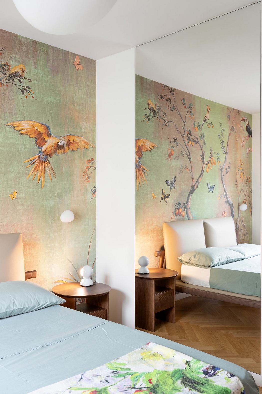 Vibrant wall mural featuring birds and butterflies adorns the elegant bedroom.