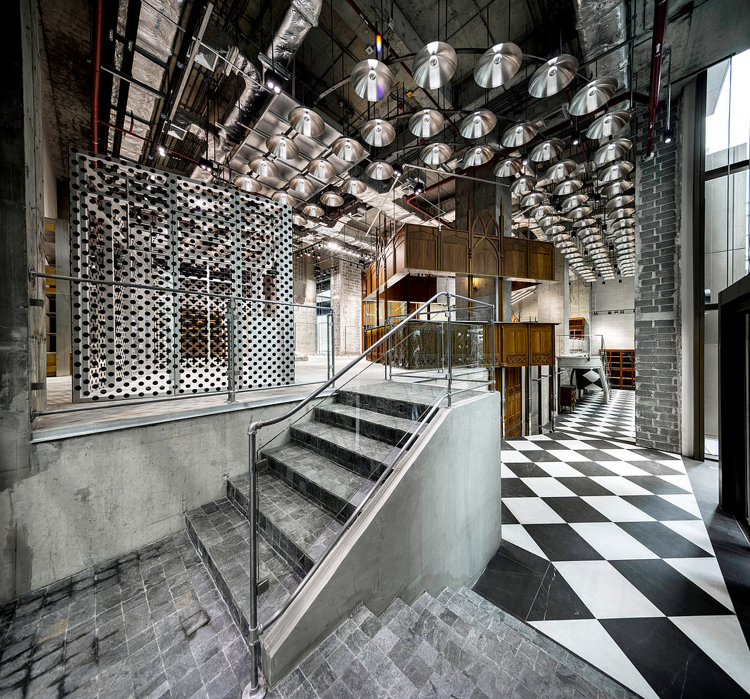 Striking industrial-style interior with geometric lighting, stairs, and patterned flooring.