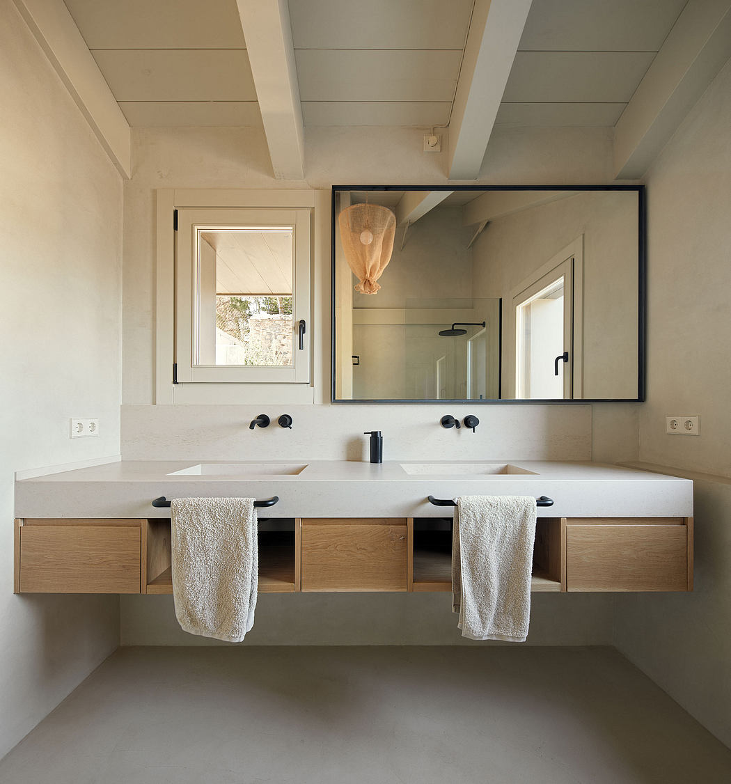 Modern, minimalist bathroom vanity with dual sinks, large mirror, and natural wood accents.