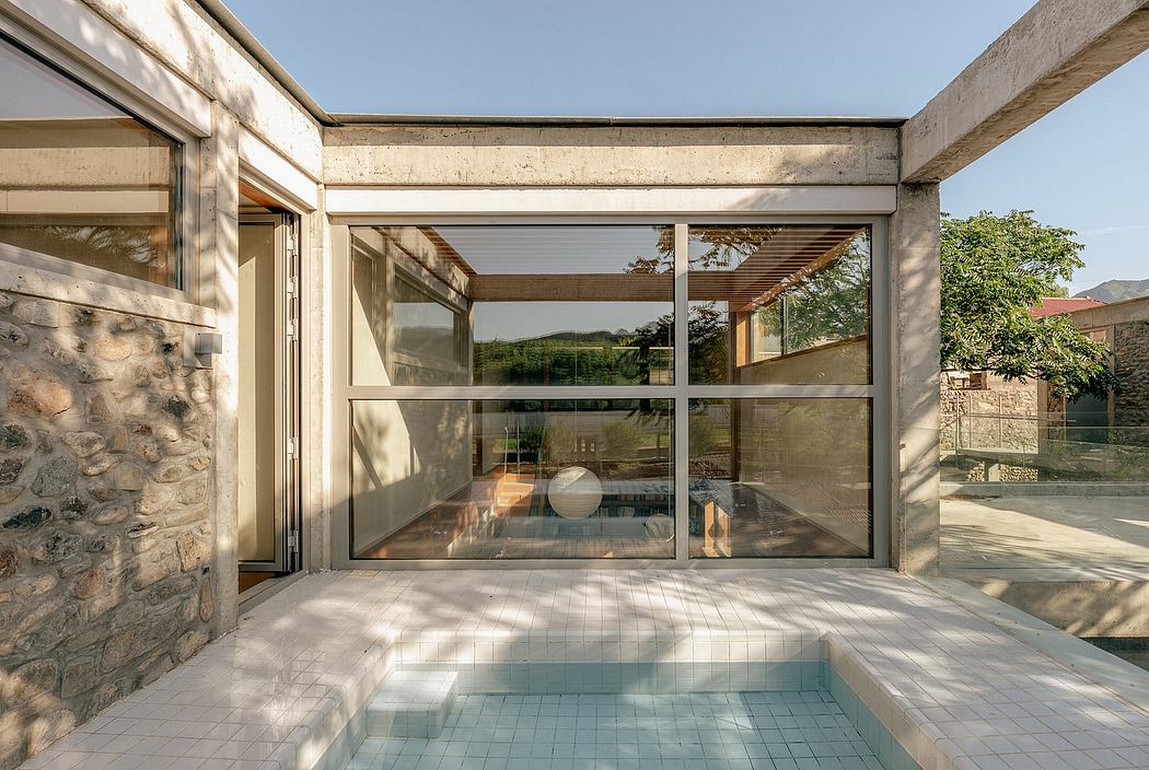 Striking glass walls and concrete frame create a seamless indoor-outdoor space.