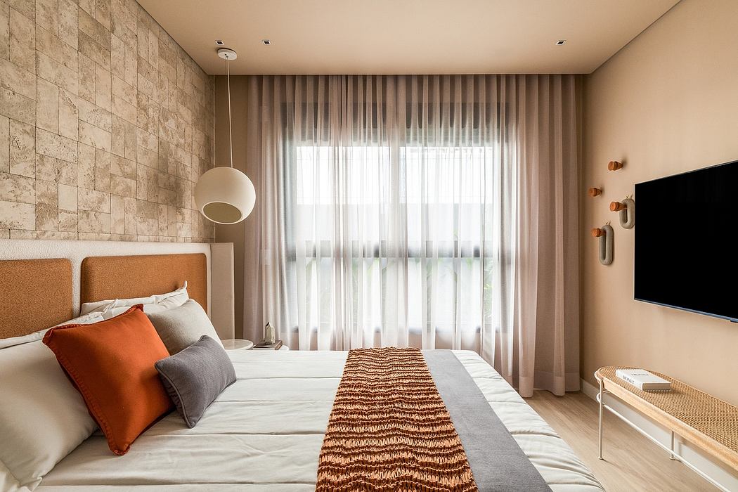 A modern bedroom with a stone accent wall, warm lighting, and floor-to-ceiling curtains.