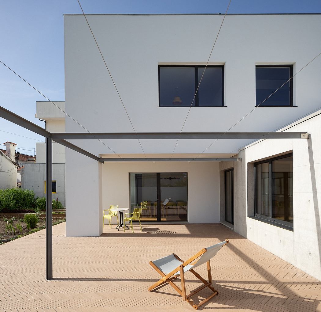 Modern residential building with clean lines, large windows, and an inviting covered patio.