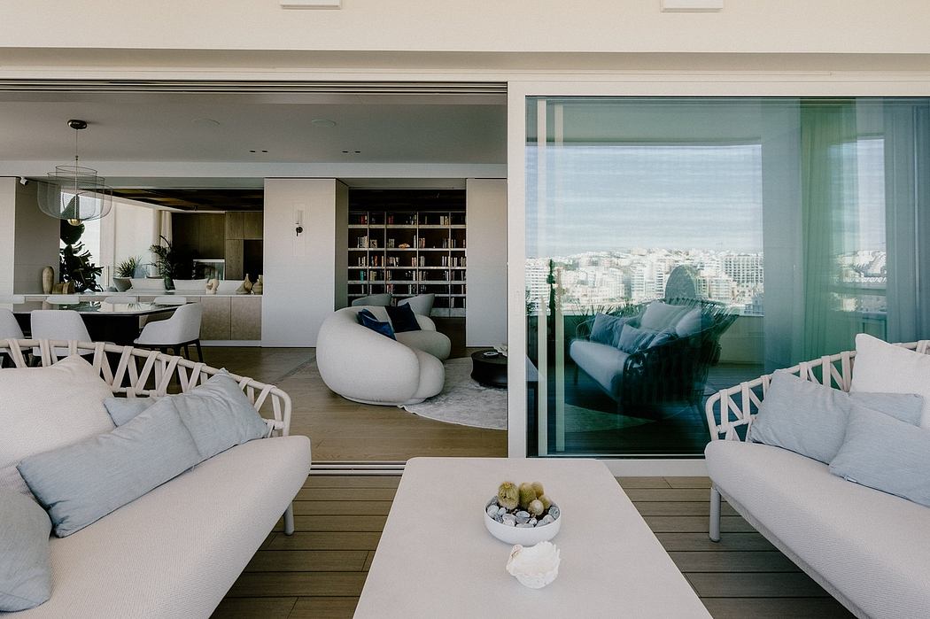 Spacious open-plan living area with panoramic city views, modern furnishings, and textural accents.