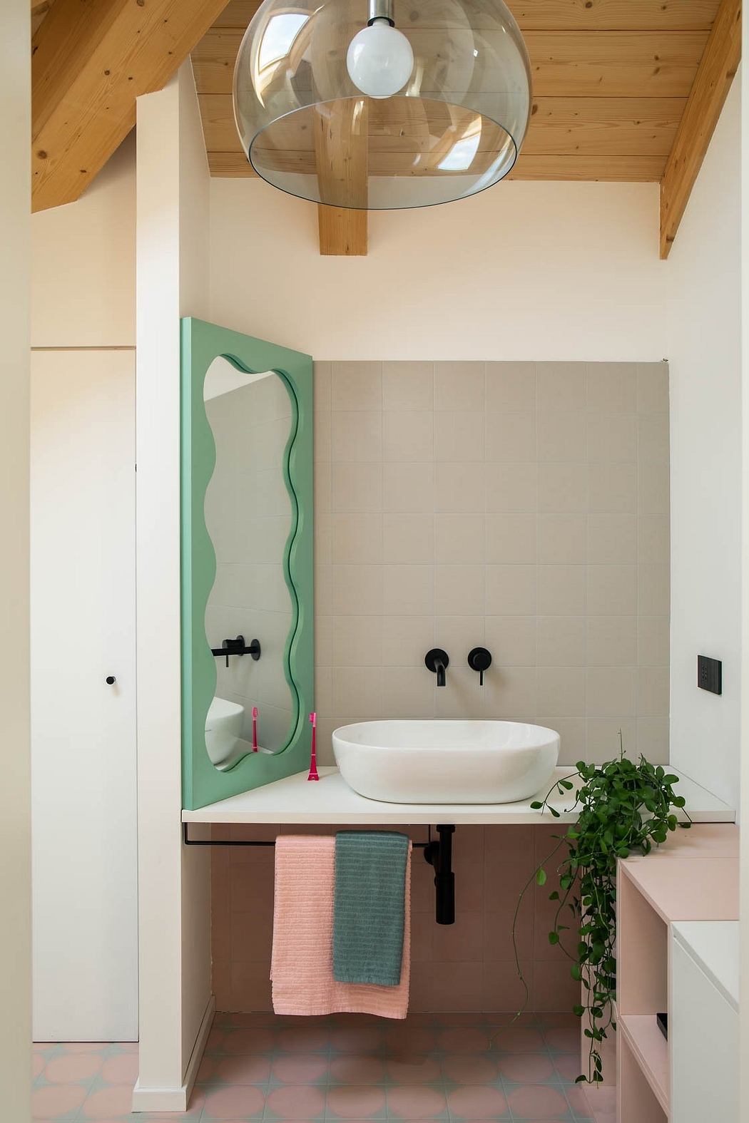 A cozy, rustic bathroom with a glass-domed light fixture and a modern, oval sink vanity.