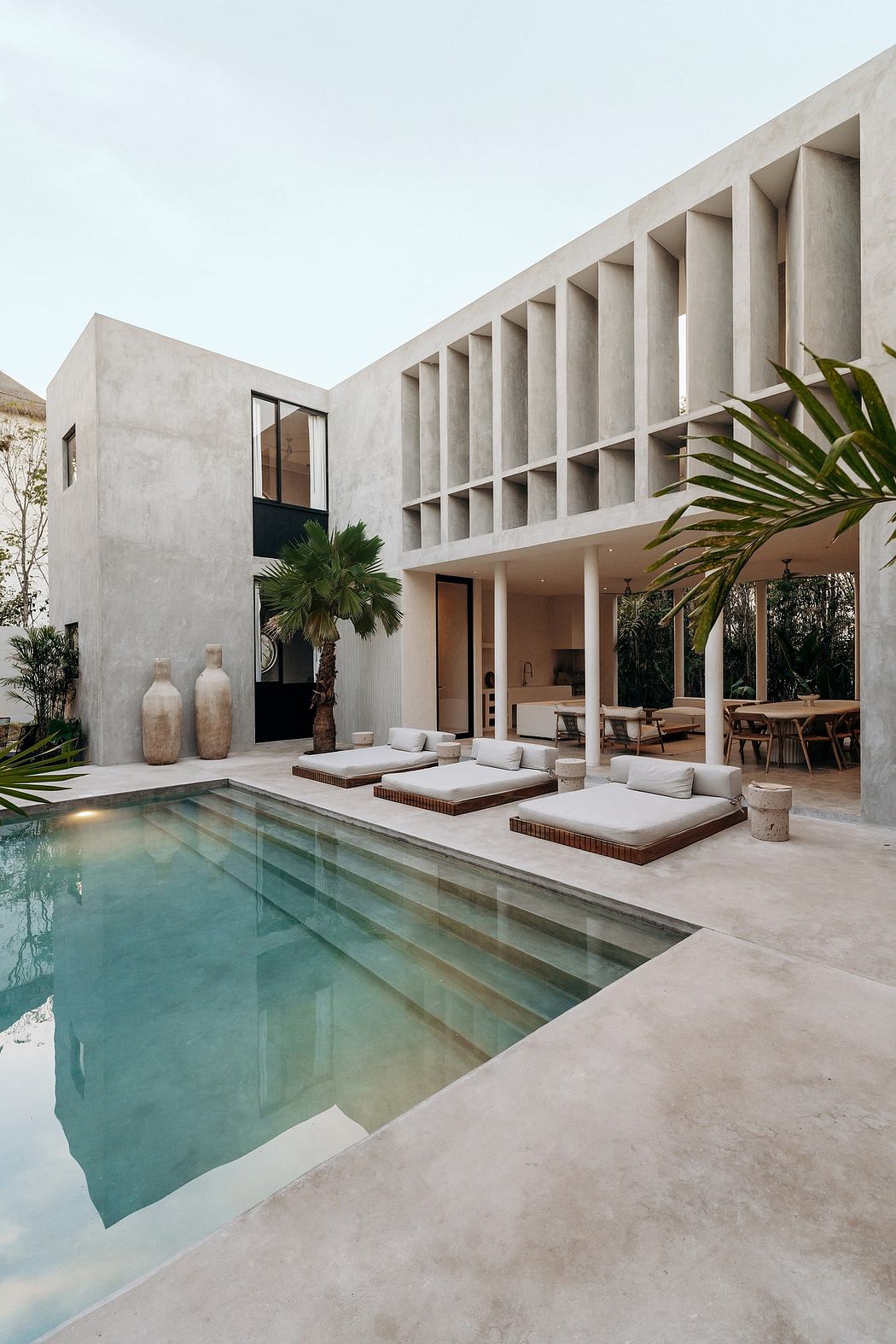 Contemporary Mediterranean-style villa with minimalist architecture, pool, and lounge area.